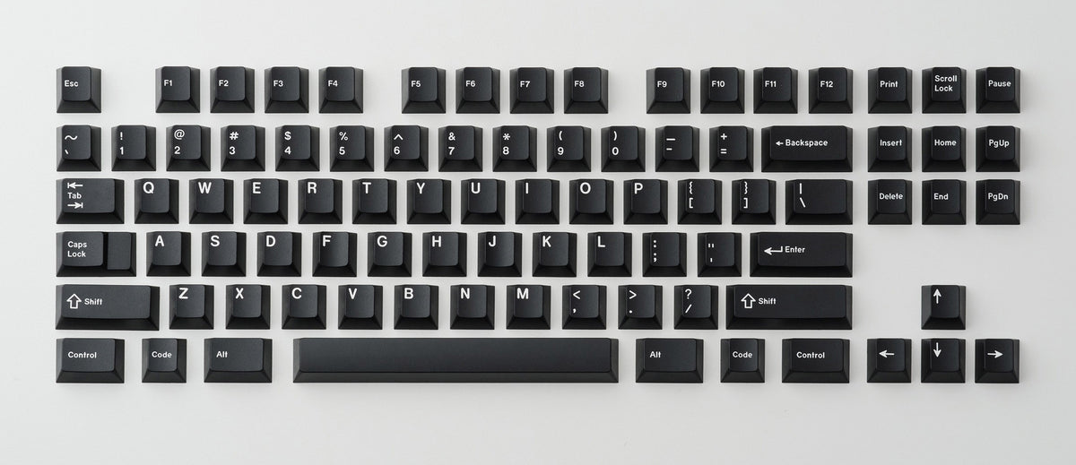 GMK CYL White on Black keycap set laid out on a neutral background, showing black caps with crisp white legends