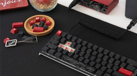 Black and red keycap set shown on Ducky One 2 mini keyboard